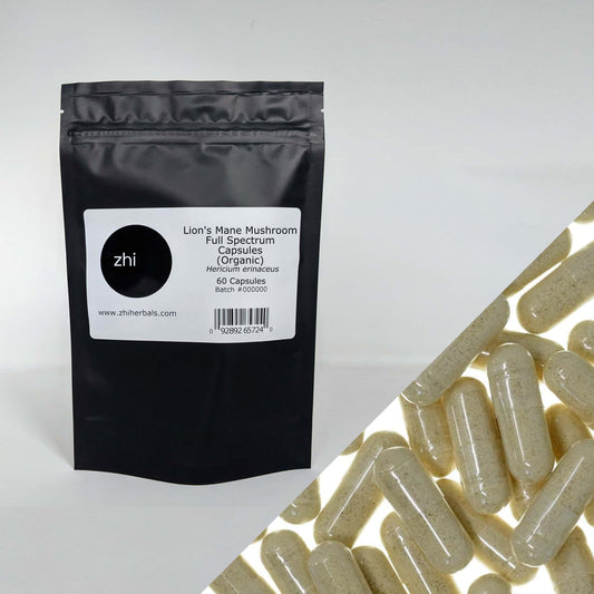 Zhi Herbals Organic Lion's Mane Mushroom Capsules, in a black package with label, next to a close-up of beige capsules.