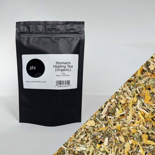 Zhi Herbals Organic Stomach Healing Tea, 50g black package with label, next to a close-up of the brown and yellow herbs.
