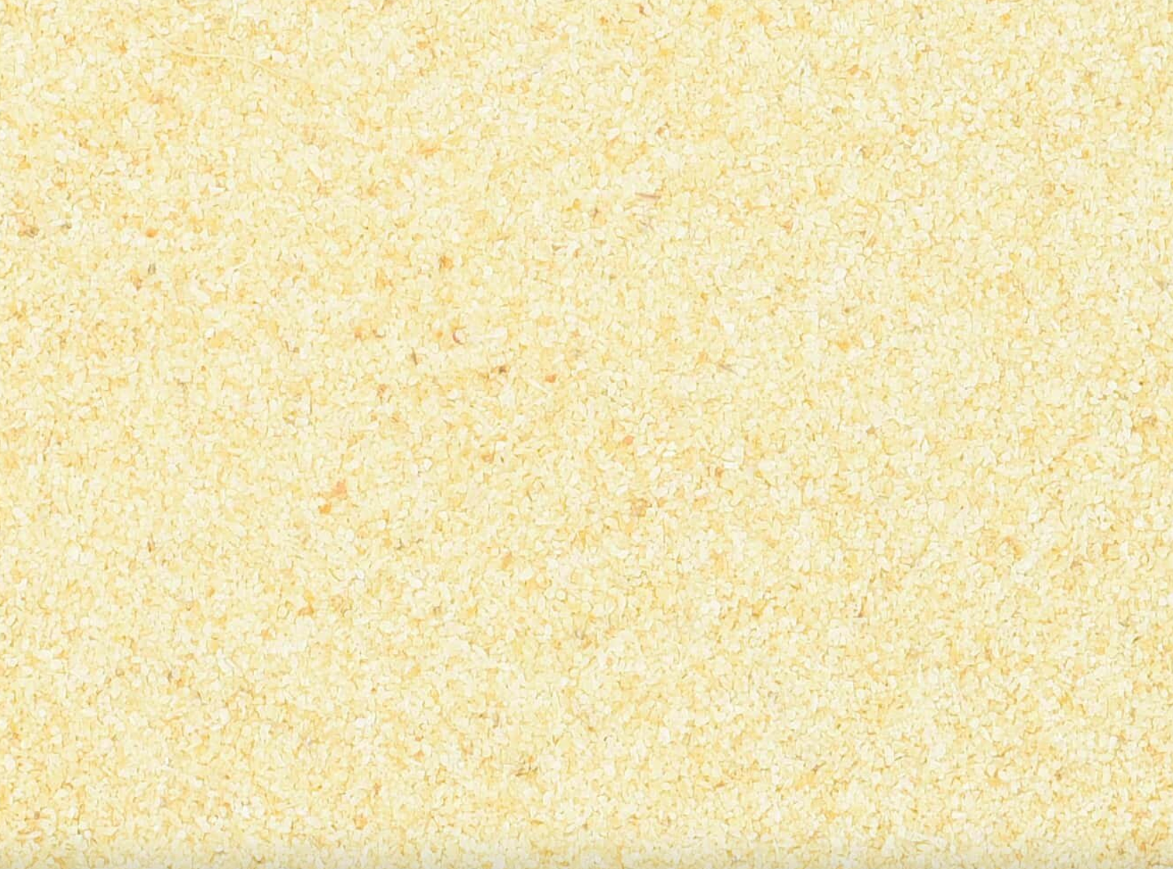 Close-up of dried garlic powder, showing finely ground beige powder used for teas and herbal remedies.