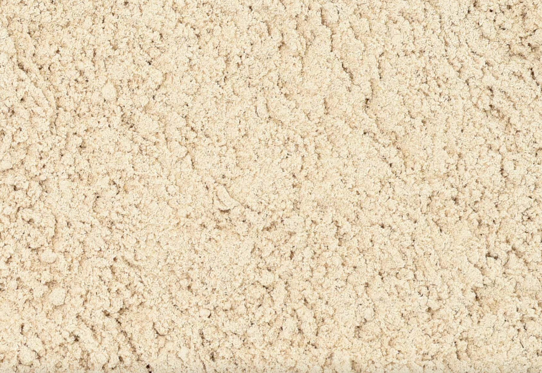 Close-up of dried slippery elm bark powder, showing beige powder used for teas and herbal remedies.